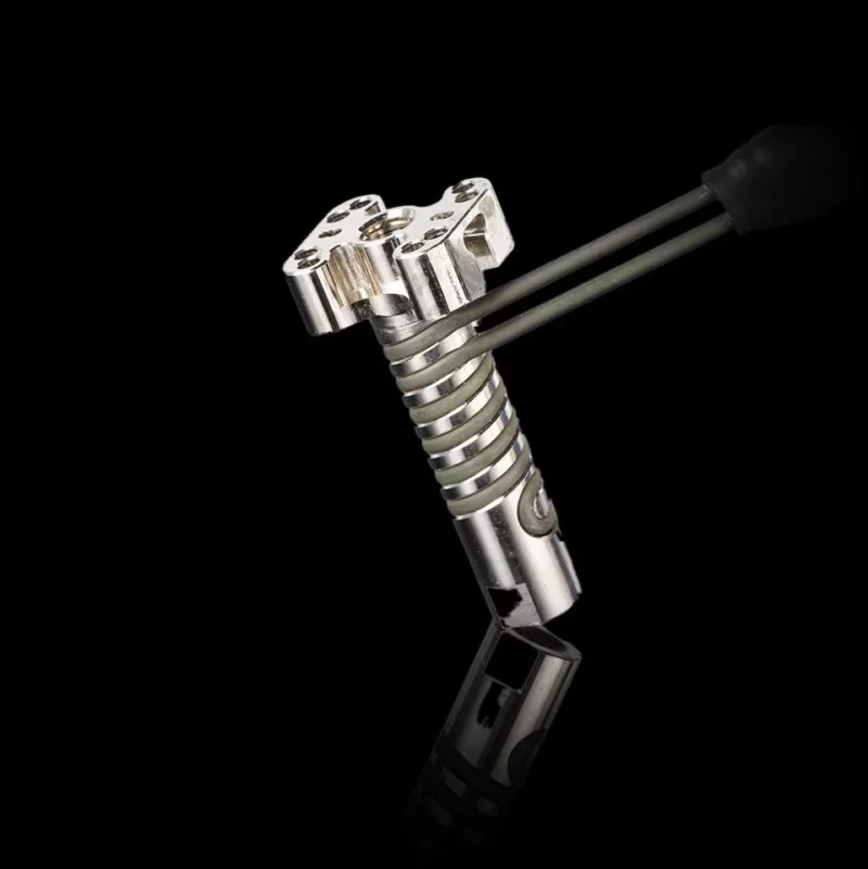 Crazy Volcano Goliath Heating Block: Silver metal heating block with a unique design and attached tubing for vaporizing.