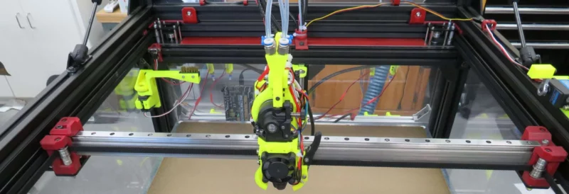 RatRig V-Core 4 3D printer with Toro-Titanium-Tube, featuring a custom build with a yellow print head and clear enclosure