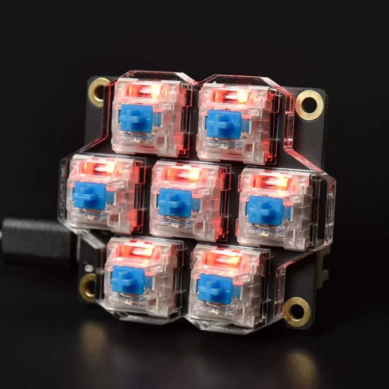 BigTreeTech HBB/HBB Fe: Electronic device featuring clear plastic switches with blue buttons and illuminated red lights.