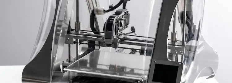 3D printer inside a clear enclosure, ready for printing