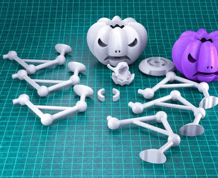 3D-printed pumpkin faces and support structures, ready for assembly.