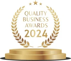 Quality Business Awards 2024 logo on a golden pedestal, business award winners