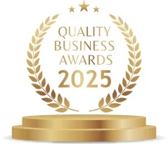 Quality Business Awards 2025 logo: Gold laurel wreath, stars, and podium for business excellence.