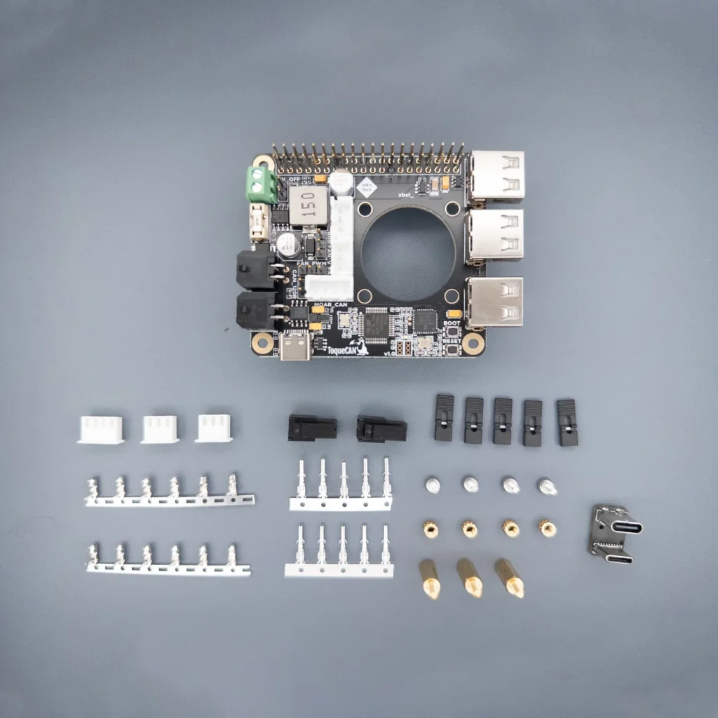 ToqueCAN board with connectors, accessories, and various electronic components.