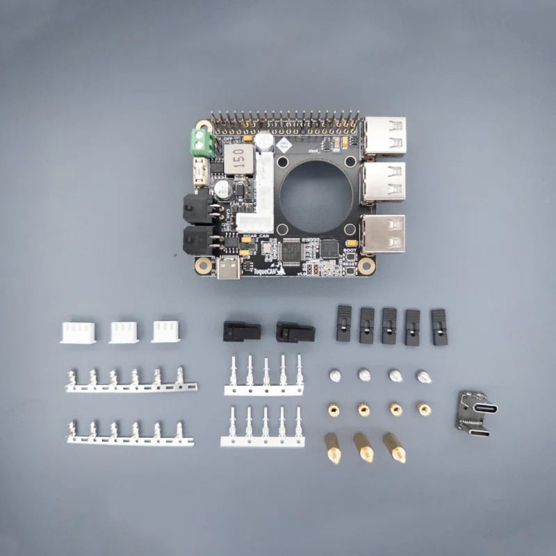 ToqueCAN board with connectors, accessories, and various electronic components.