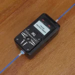 Panda Bamboo Feeder: Black electronic device with blue cable, displaying "Panda Bamboo Feeder" on screen.